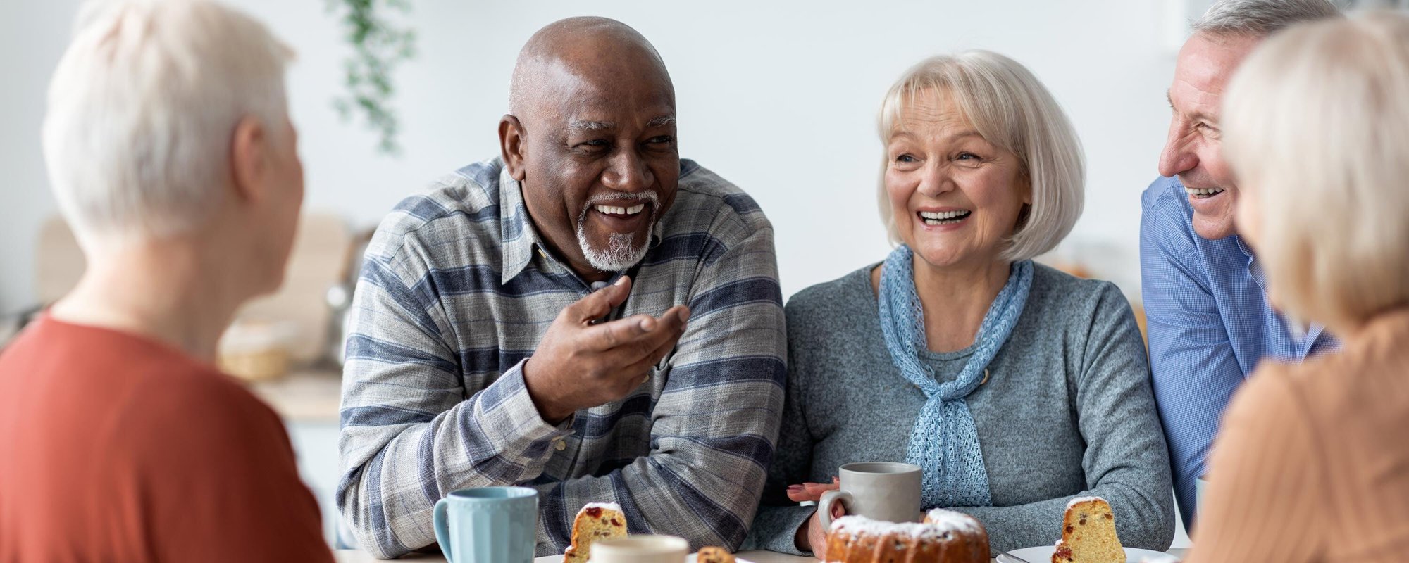 group of independent seniors having coffee and dessert