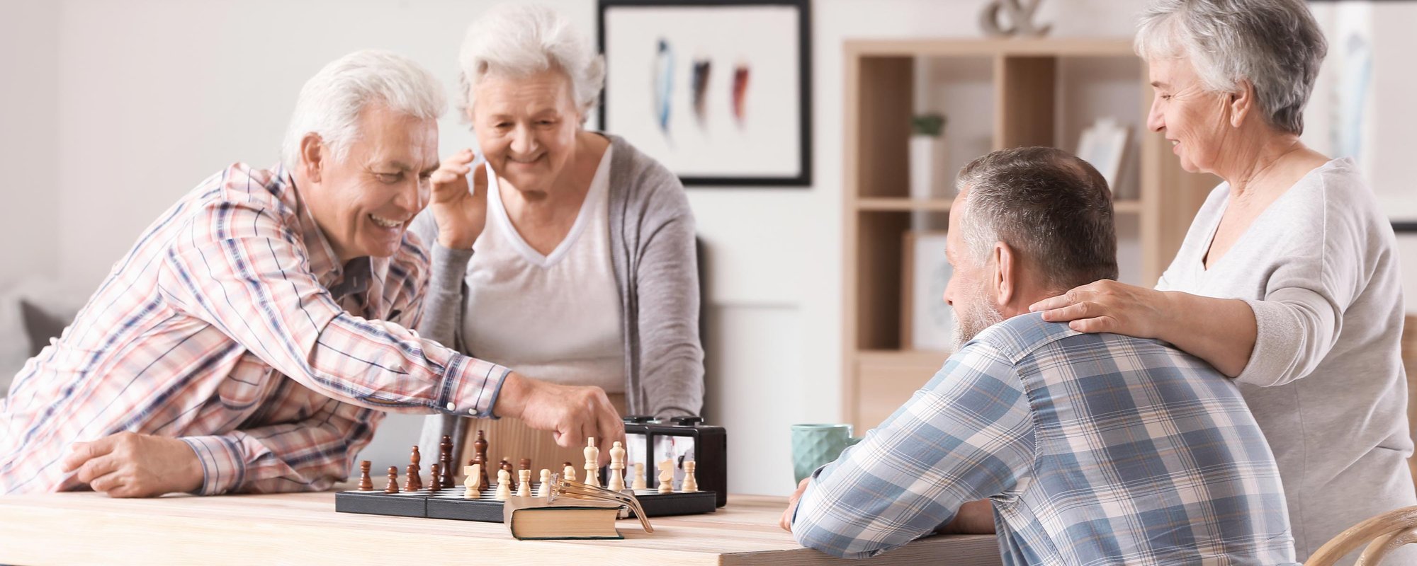 seniors smiling while playing chess